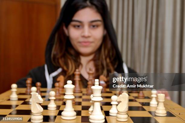 a teenager girl showing board game chess - punjabi girls images 個照片及圖片檔