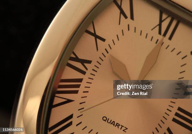 man's wristwatch against black background set at 10:00 in roman numerals - luxury watch stock pictures, royalty-free photos & images