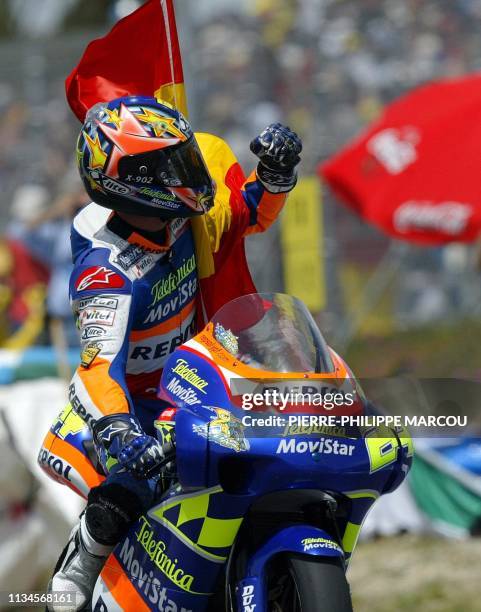 Spanish Toni Elias celebrates with his national flag after winning the 250 cc category of the motorcycle Grand Prix of Spain 11 May 2003, in Jerez....