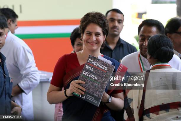 Priyanka Gandhi Vadra, general secretary of the Congress party, holds up a copy of the Congress manifesto at an event marking the document's launch...