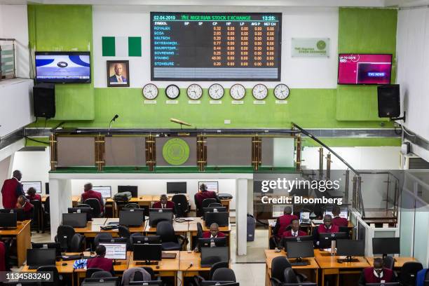 Employees work on the trading floor at the Nigerian Stock Exchange in Lagos, Nigeria, on Tuesday, April 2, 2019. The International Monetary Fund said...