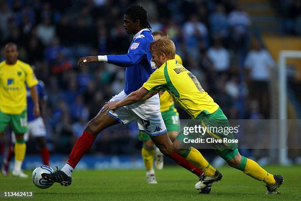 Kanu of Portsmouth is challeneged by Zak Whitbread of Norwich City during the npower Championship match between Portsmouth and Norwich City at...