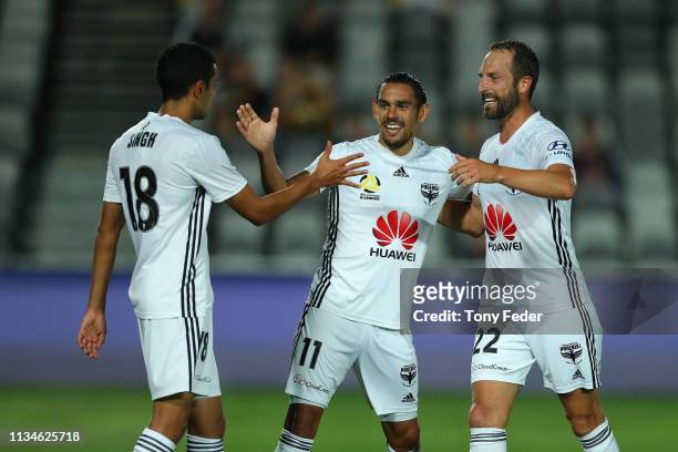David Williams of Wellington Phoenix celebrates a goal with team mates Andrew Durante and Sarpreet Singh during the round 21 A-League match between...