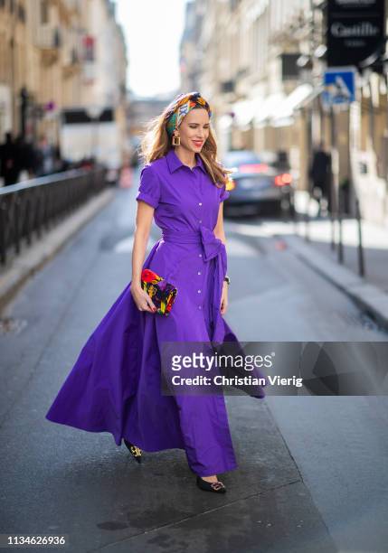 Alexandra Lapp wearing a long purple taffeta gown from P.A.R.O.S.H. With a wide cut out leg, multicolored silk scarf from Hermès, the small BB clutch...