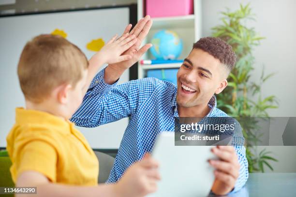 class high five - high five stock pictures, royalty-free photos & images