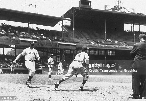 Josh Gibson, catcher for the Negro League Homestead Grays, is approaching first base as he runs out a ground ball in Griffith Stadium circa 1940 in...