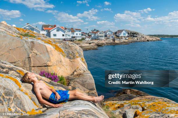 teen sunbathing in swedens idyllic archipelago - boat scandinavia stock pictures, royalty-free photos & images