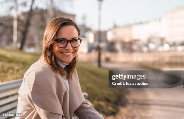 female university student is reading a book in the city - scandinavian descent stock pictures, royalty-free photos & images