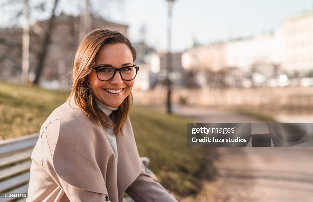 Kvinnliga universitets studerande läser en bok i staden