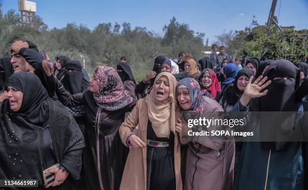 Relatives of the deceased are seen mourning during the funeral ceremony of Faris Abu Hijras who was killed by Israeli troops east of Khuza'a near the...