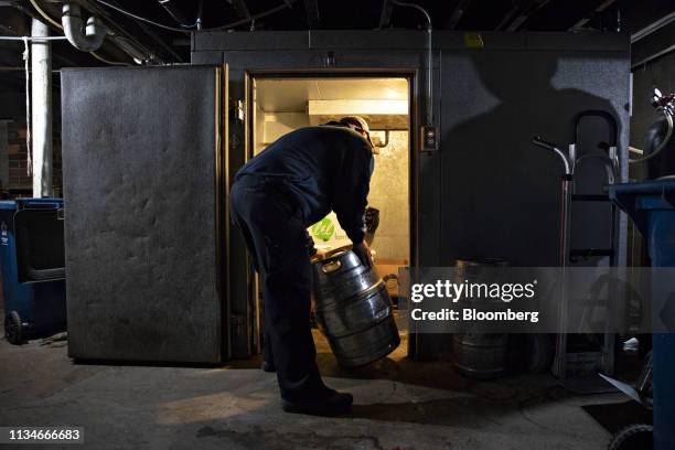 Driver moves a keg of beer into a cooler during a delivery in Ottawa, Illinois, U.S., on Tuesday, April 2, 2019. Constellation Brands is scheduled to...