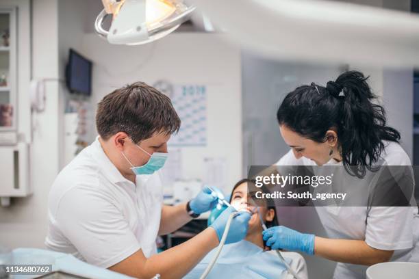 dentist and patient in dental office - dental assistant stock pictures, royalty-free photos & images