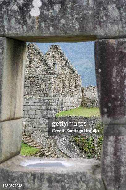 machu picchu ruins through stone window - machu pichu stock pictures, royalty-free photos & images