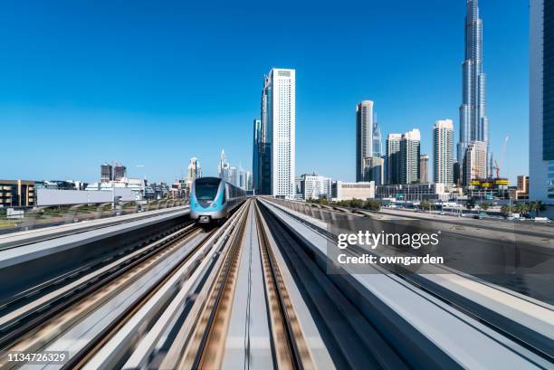 metro riding through downtown dubai - dubai metro stock pictures, royalty-free photos & images