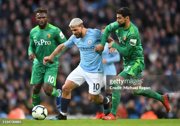 Sergio Aguero of Manchester City is challenged by Miguel Britos of Watford during the Premier League match between Manchester City and Watford FC at...