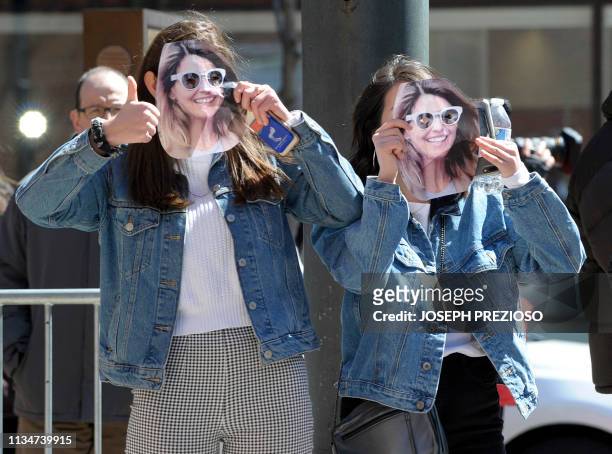 Two girls wear Lori Loughlin mask at the John Joseph Moakley United States Courthouse in Boston on April 3, 2019. Loughlin appeared in Federal Court...