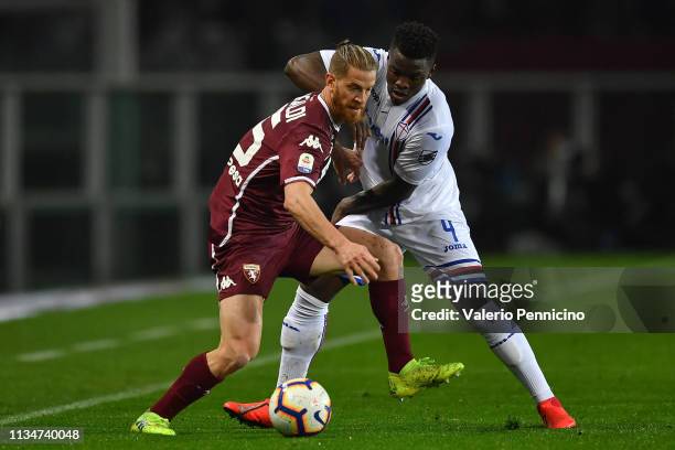 Cristian Ansaldi of Torino FC is challenged by Ronaldo Vieira of UC Sampdoria during the Serie A match between Torino FC and UC Sampdoria at Stadio...