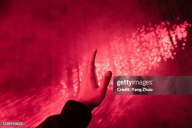 a human hand raised under red lighting - left handed stock pictures, royalty-free photos & images