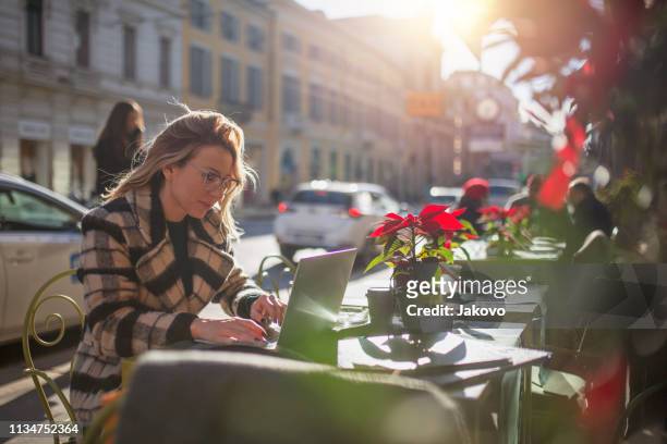 young woman enjoying in a restaurant on a sunny day - milan cafe stock pictures, royalty-free photos & images