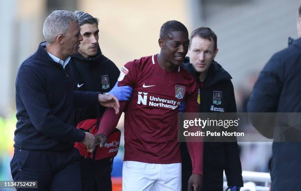 Marvin Sordell of Northampton Town is consoled by manager Keith Curle as he leaves the pitch with a head injury during the Sky Bet League Two match...