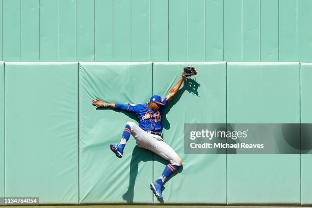 Keon Broxton of the New York Mets crashes into the wall as he attempts to catch a flyball against the Boston Red Sox in the sixth inning of the...