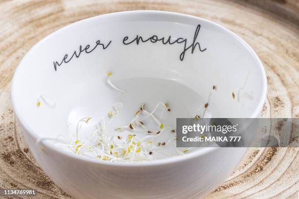 fresh alfalfa sprouts (medicago sativa) in white pottery bowl on a rustic wooden tray. - medicago sativa stock pictures, royalty-free photos & images