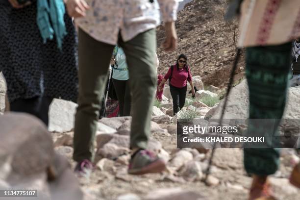 Group of hikers led by Egyptian Bedouin women guides walk in Wadi el-Sahu in South Sinai governorate on March 29 during the first "Sinai Trail" led...