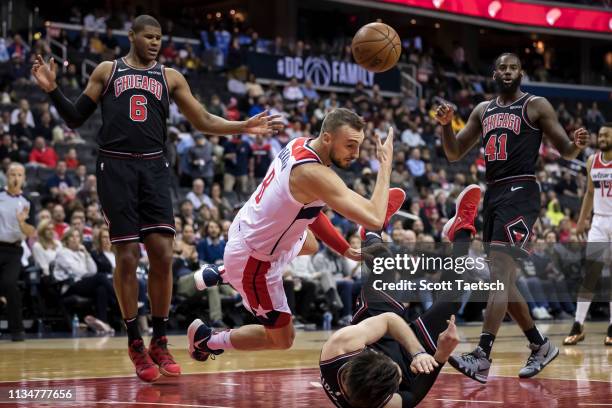 Sam Dekker of the Washington Wizards collides with Ryan Arcidiacono of the Chicago Bulls during the first half at Capital One Arena on April 3, 2019...