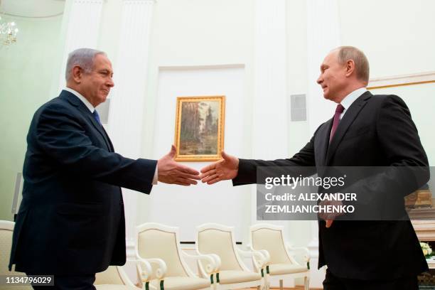 Russian President Vladimir Putin shakes hands with Israeli Prime Minister Benjamin Netanyahu, during their meeting at the Kremlin in Moscow on April...