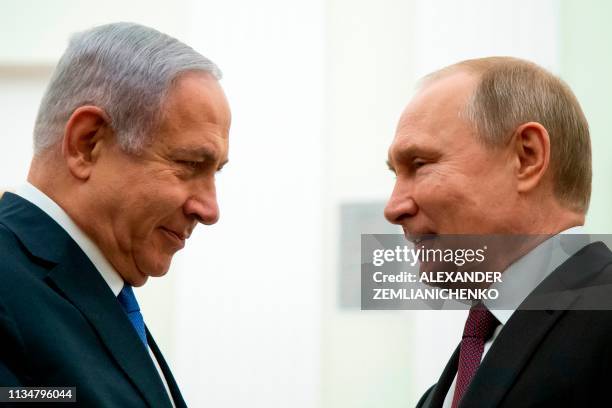 Russian President Vladimir Putin speaks with Israeli Prime Minister Benjamin Netanyahu, during their meeting at the Kremlin in Moscow on April 4,...