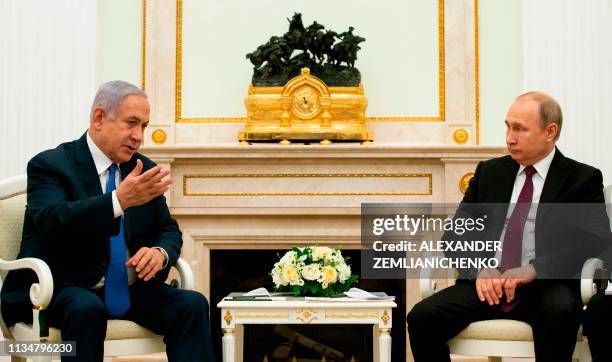 Russian President Vladimir Putin speaks with Israeli Prime Minister Benjamin Netanyahu during their meeting at the Kremlin in Moscow on April 4, 2019.