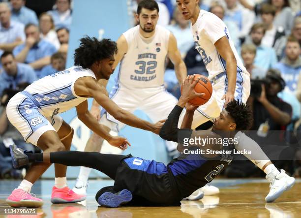 Coby White of the North Carolina Tar Heels goes after a loose ball against Cam Reddish of the Duke Blue Devils during their game at Dean Smith Center...