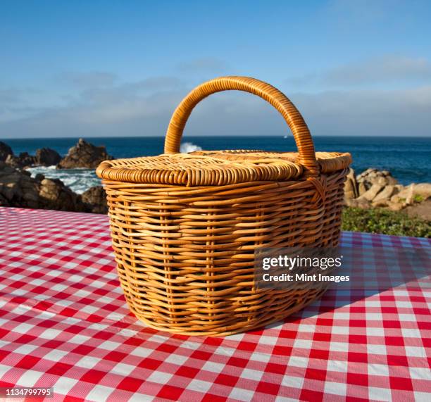 picnic basket on wooden picnic table - picnic basket stock pictures, royalty-free photos & images
