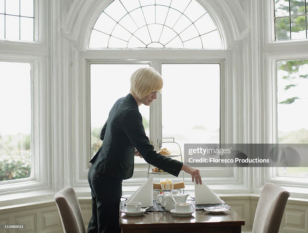 Woman setting up table