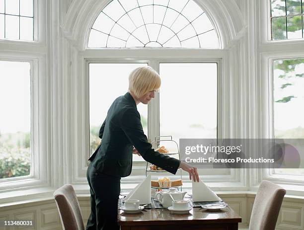 woman setting up table - premium tea bildbanksfoton och bilder