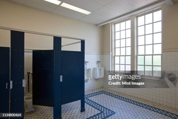 male bathroom of a school - public bathroom stock pictures, royalty-free photos & images