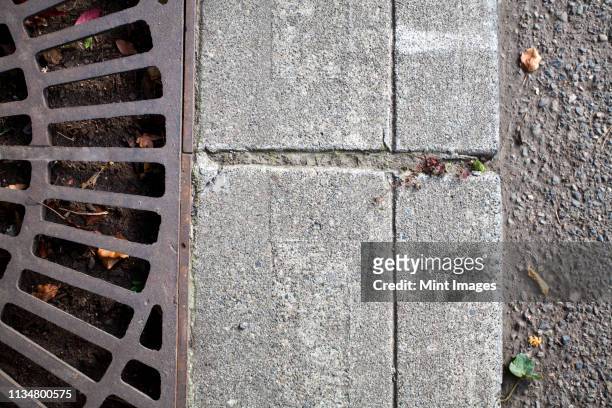 metal grate on sidewalk - drain stock pictures, royalty-free photos & images
