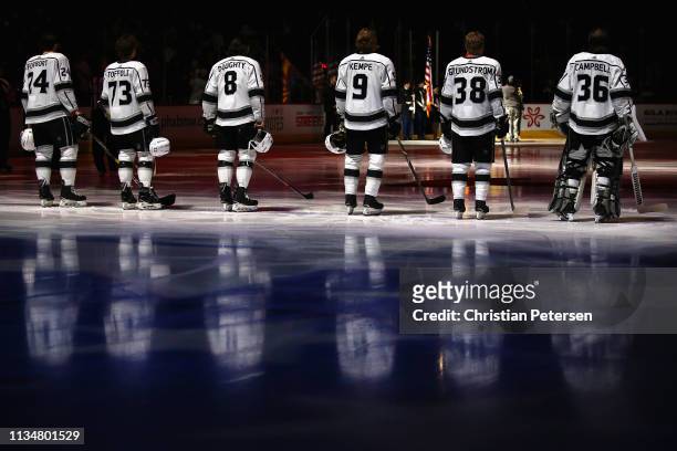 Derek Forbort, Tyler Toffoli, Drew Doughty, Adrian Kempe, Carl Grundstrom and goaltender Jack Campbell of the Los Angeles Kings stand attended for...