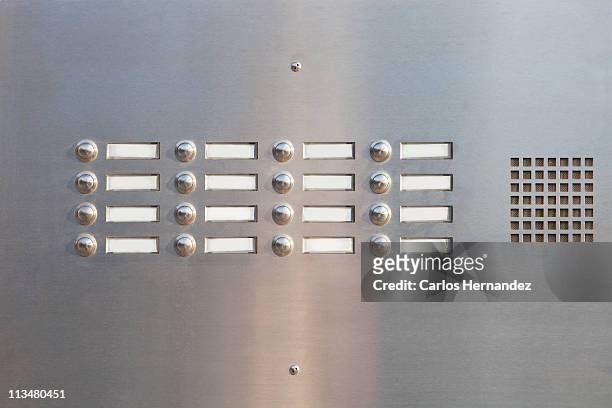 a panel of doorbells - klingelschild stock-fotos und bilder