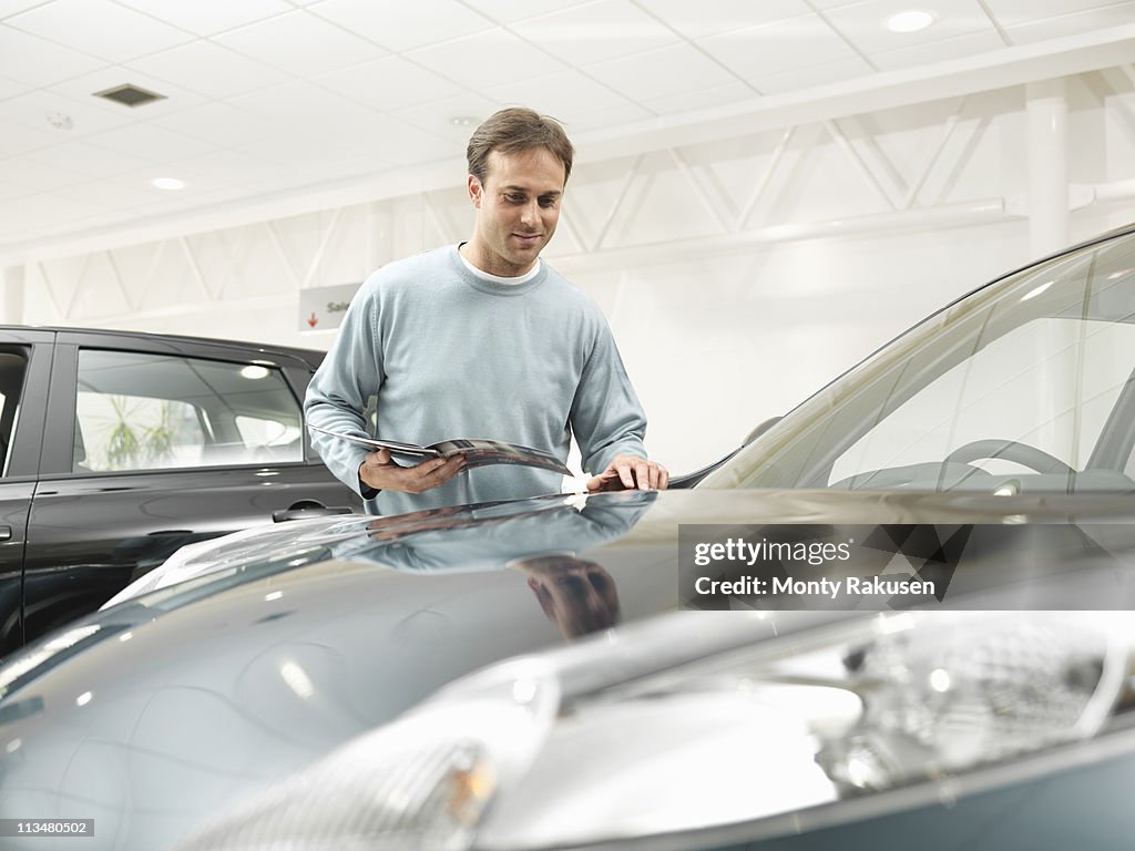 Customer looks at car in car dealership