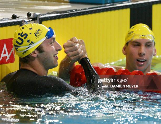 Australian gold medalist Ian Thorpe shakes hands with compatriot silver medalist Grant Hackett after they both broke the world record during the 2002...