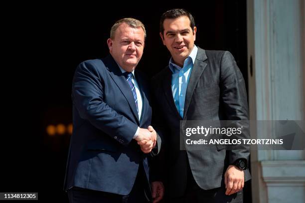 Greek Prime Minister Alexis Tsipras shakes hands as he welcomes his Danish counterpart Lars Lokke Rasmussen prior to a meeting at the Maximos Mansion...