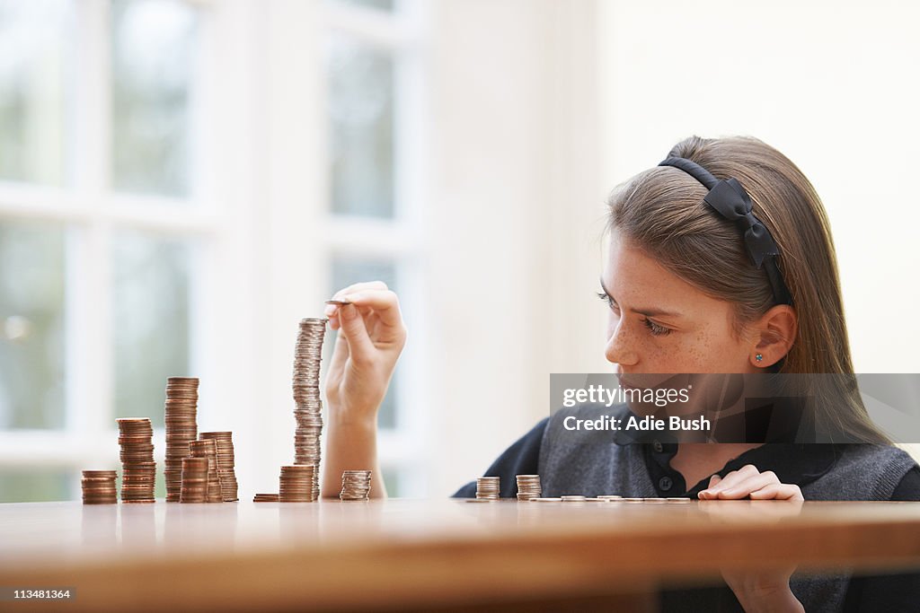 Girl Counting money at a table