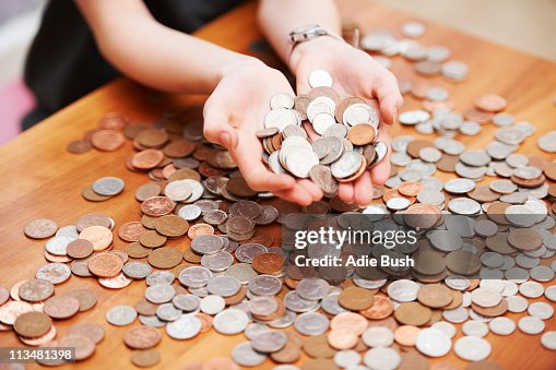 Girl holding coins in her hands Girl holding coins in her hands