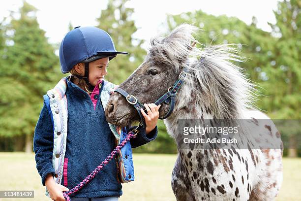young girl with her pony - child horse stock pictures, royalty-free photos & images