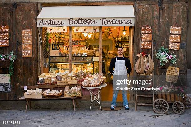 owner standing in front of deli - arezzo stockfoto's en -beelden