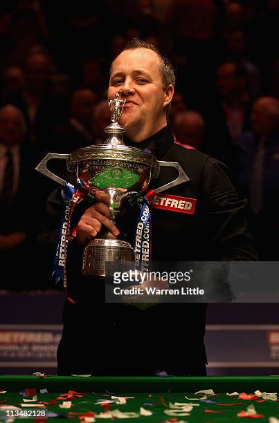 John Higgins of Scotland poses with the trophy after beating Judd Trump of England to win the Betfred.com World Snooker Championship at the Crucible...