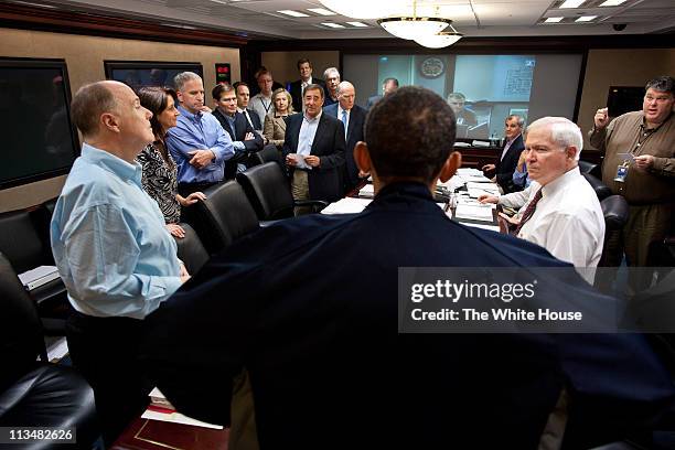 In this handout image provided by The White House, President Barack Obama talks with members of the national security team at the conclusion of one...