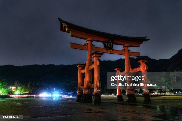 itsukushima shrine's torii gate - a unesco world heritage site - torii gate stock pictures, royalty-free photos & images