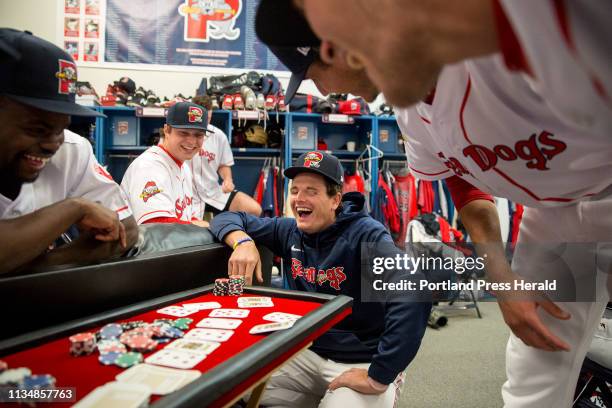 Tate Matheny, center, laughs while playing Texas Hold Em with teammates in the locker room during Sea Dogs media day on Saturday, April 2, 2019.